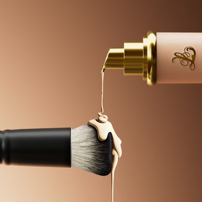 Makeup brush with cream being applied against a brown background